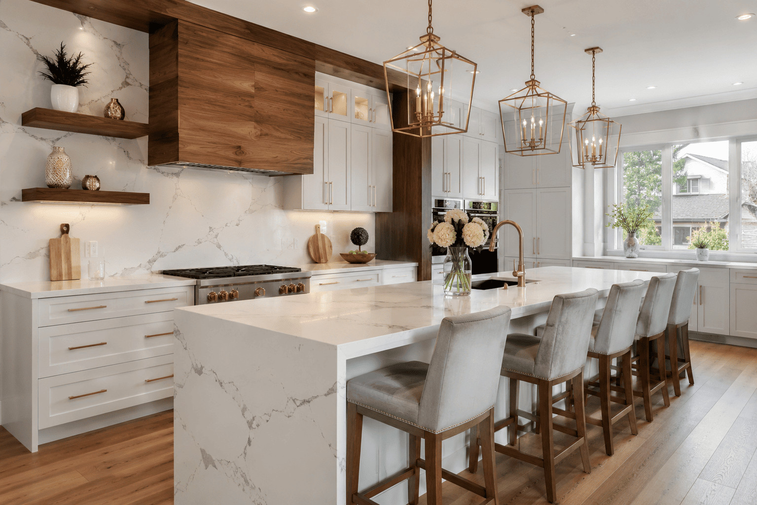 Modern kitchen featuring premium quartz countertops Kitchener with a white waterfall island, custom cabinetry, and elegant marble-look surfaces.