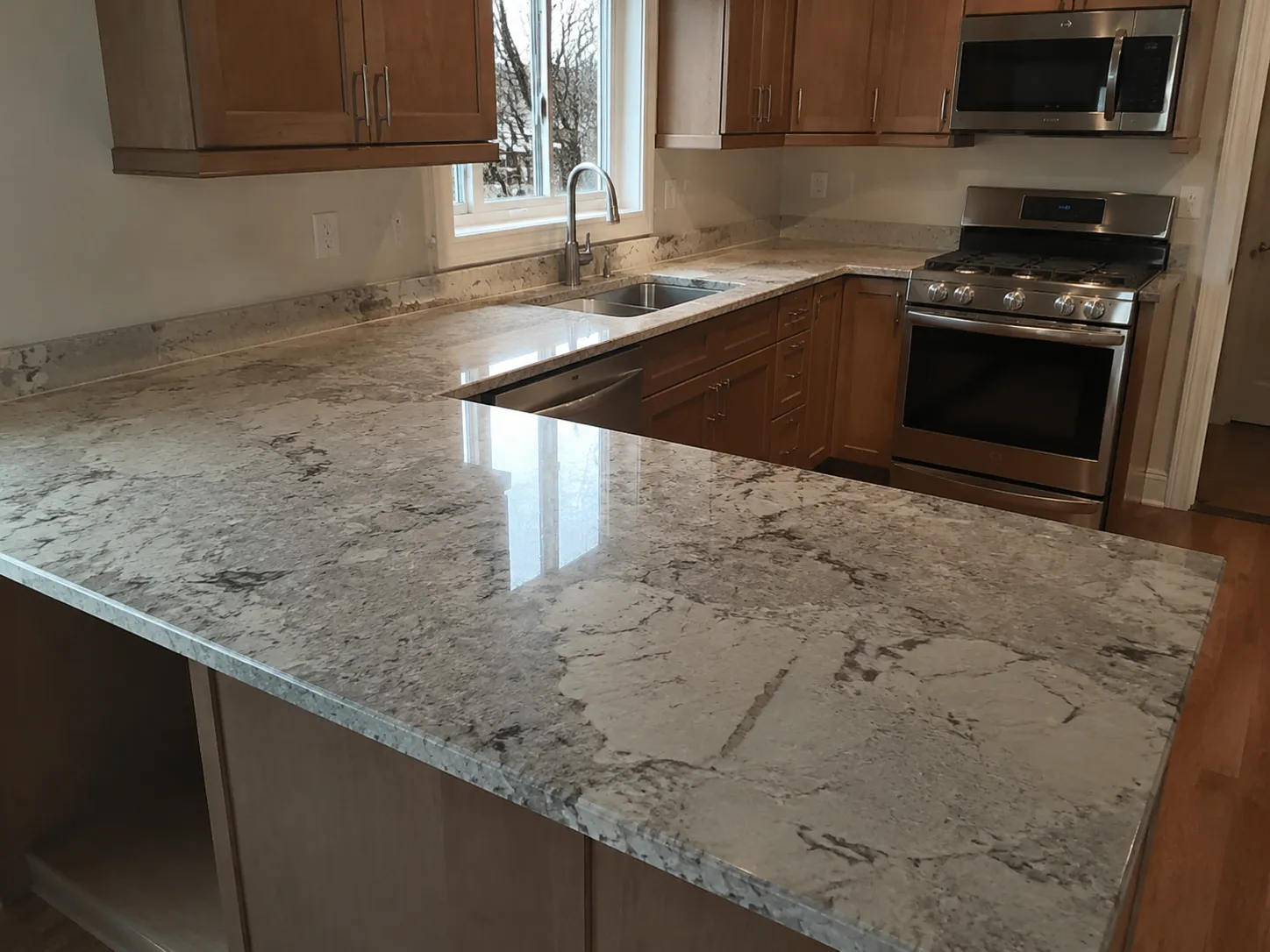 Local countertop installers completing a modern kitchen countertop renovation with quartz surfaces